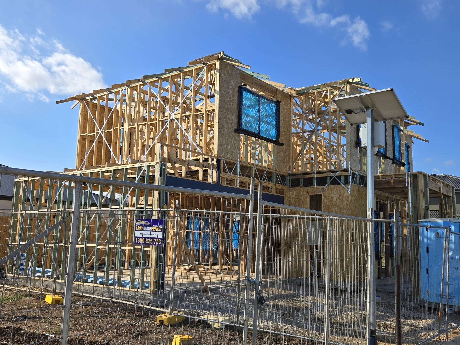 Two-storey timber house frame under construction on a residential building site in Melbourne
