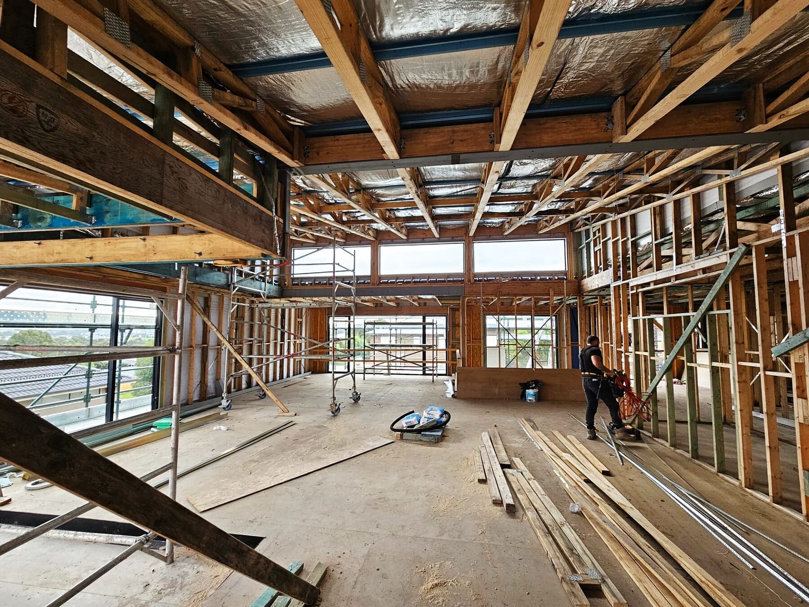 Open-plan custom home interior with timber framing and structural steel beams in Doreen VIC - Master Framers