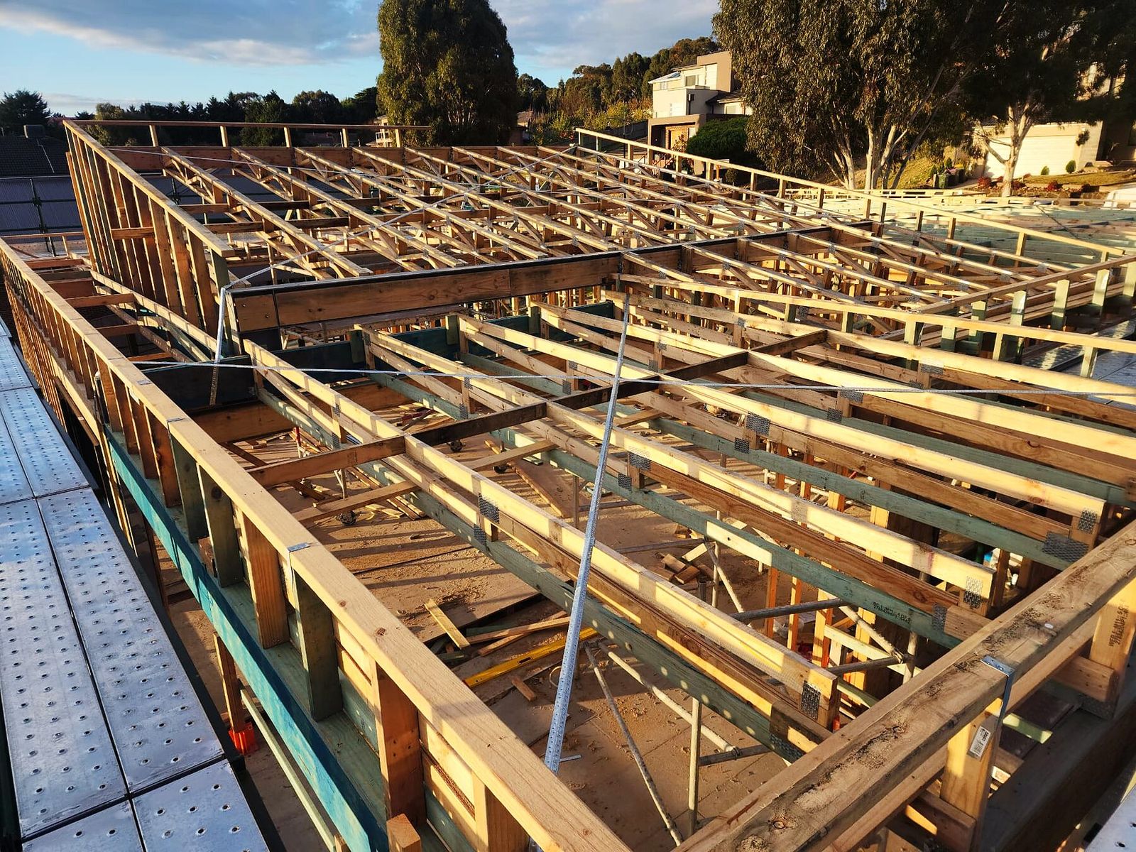 Timber floor framing tied into structural steel beams on a Doreen custom home - Master Framers
